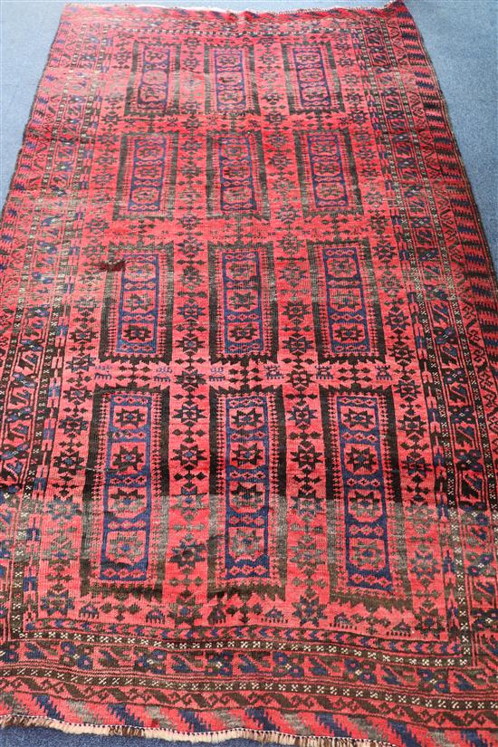 A Baluchi red and blue ground rug, 220 x 125cm
